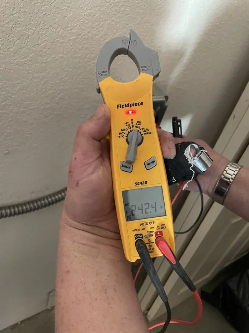 Voltage testing with clamp meter during Recessed Lighting Installation in Old Lycoming
